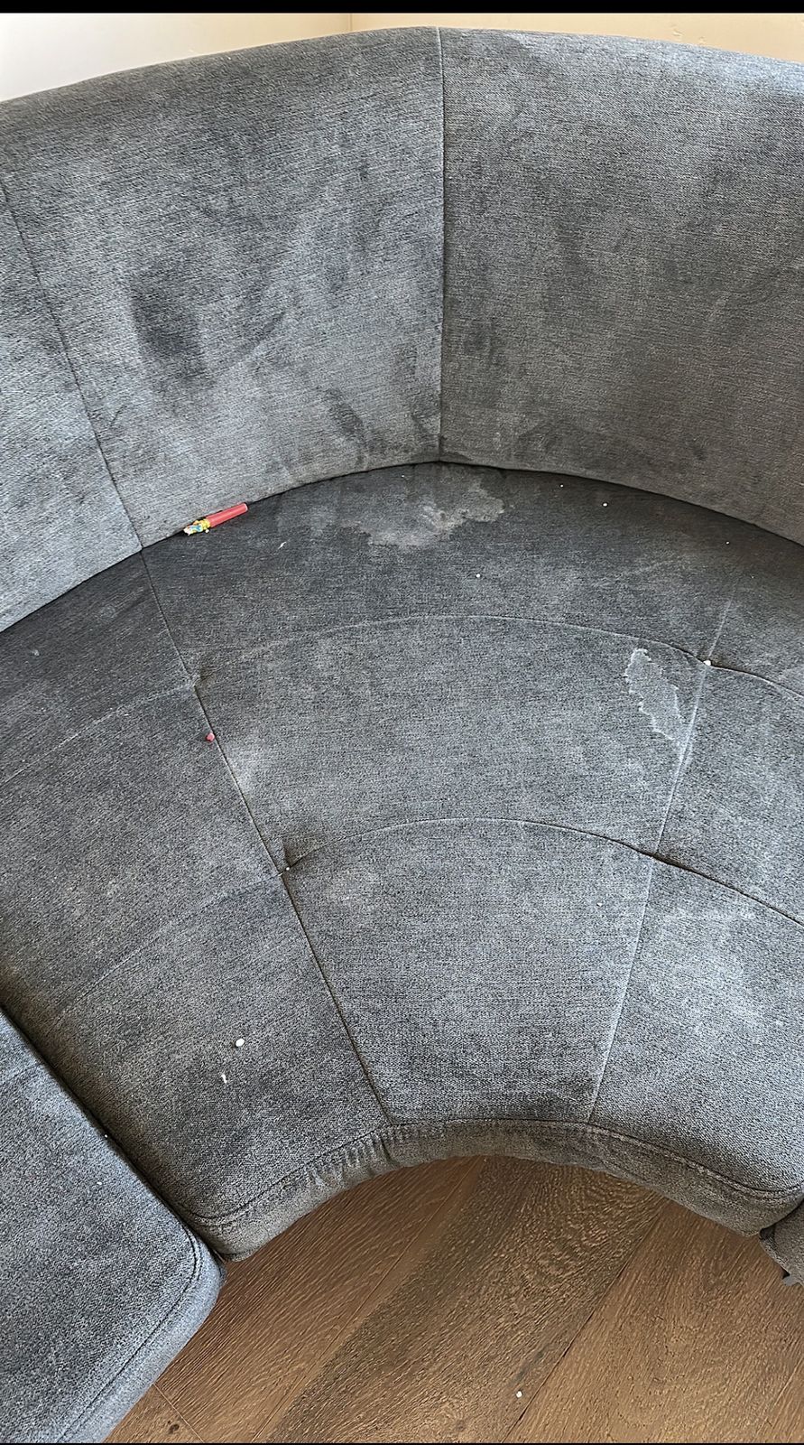 Gray loveseat before cleaning