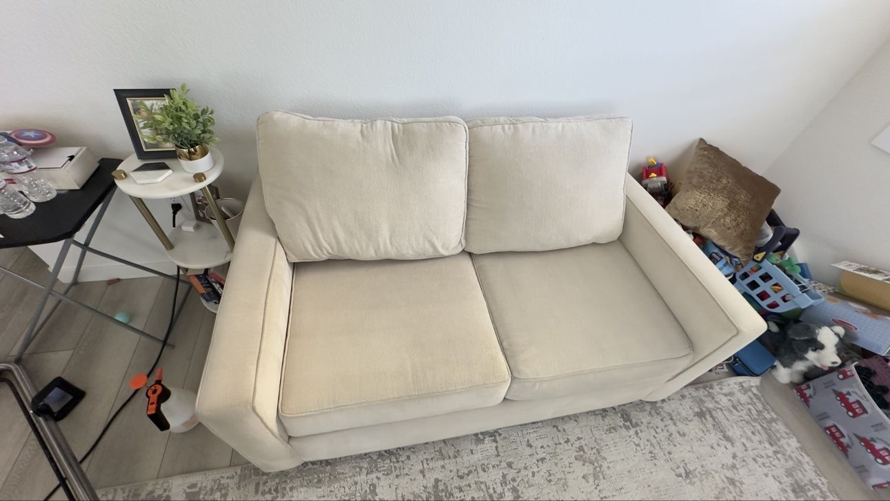 Beige two-seater sofa after cleaning