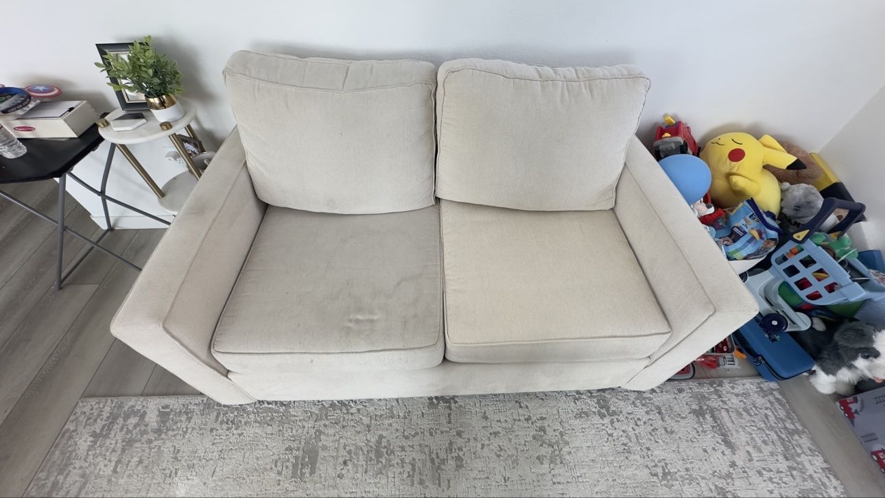 Beige two-seater sofa before cleaning