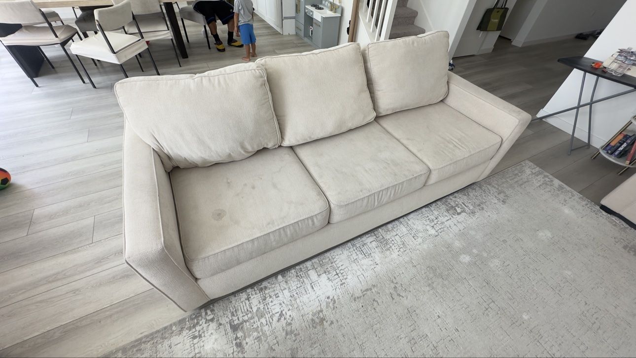 Beige three-seater sofa before cleaning