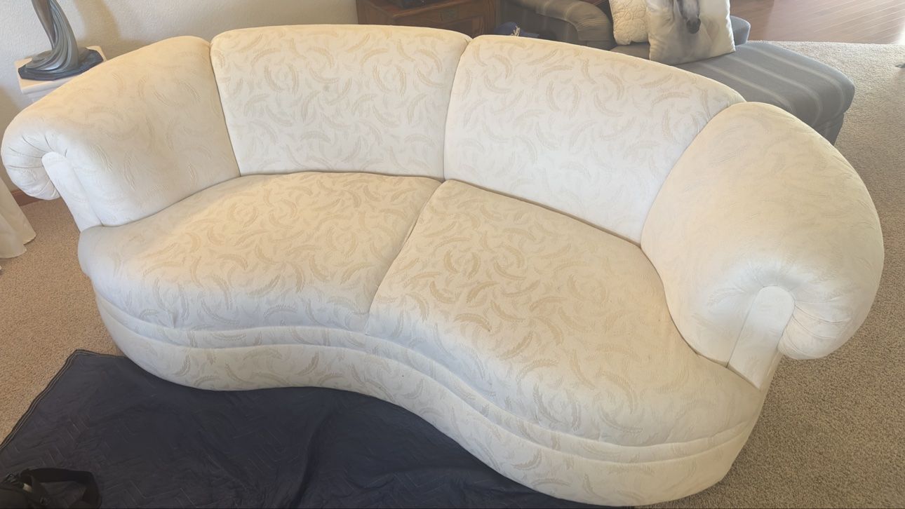 White curved loveseat after cleaning