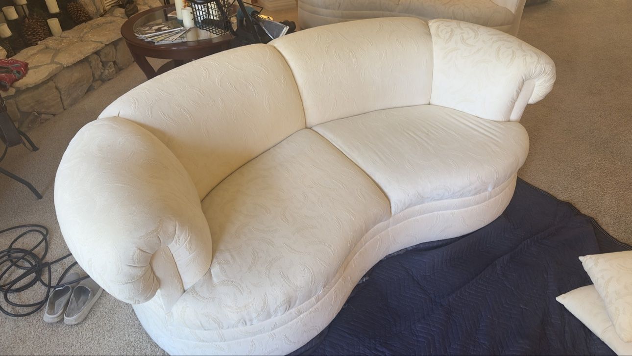 White curved loveseat after cleaning, alternate angle